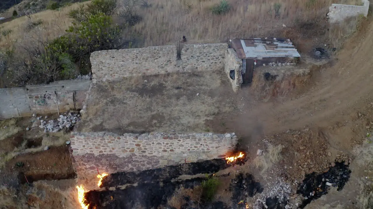 A fire has broken out on a hill over some grain and it has been burning in the fire for a long time