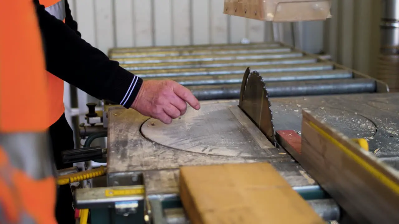 Man in front of a wood cutting machine