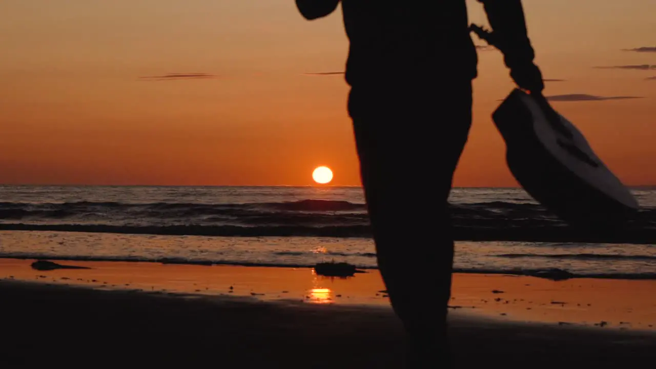 Man running with guitar in back sand beach at sunset-13