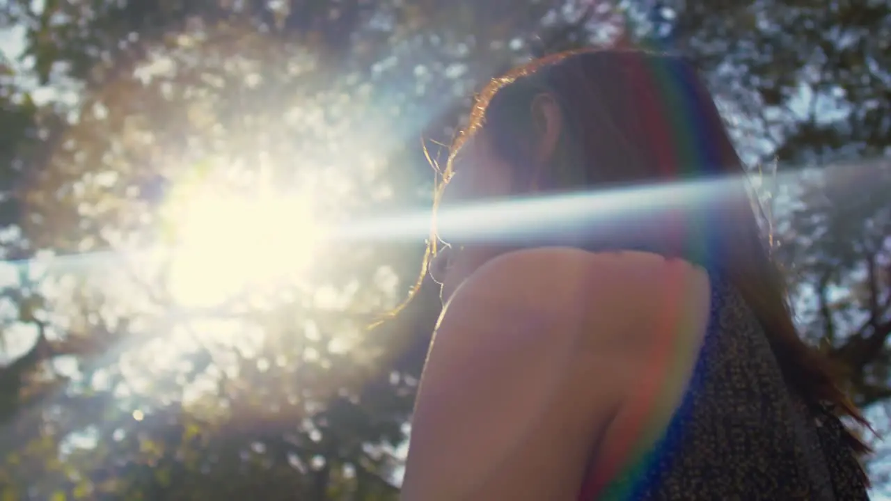 Young attractive woman enjoying warm spring sun outdoors low angle medium shot