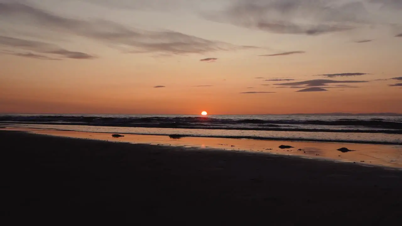 Man running with guitar in back sand beach at sunset-32