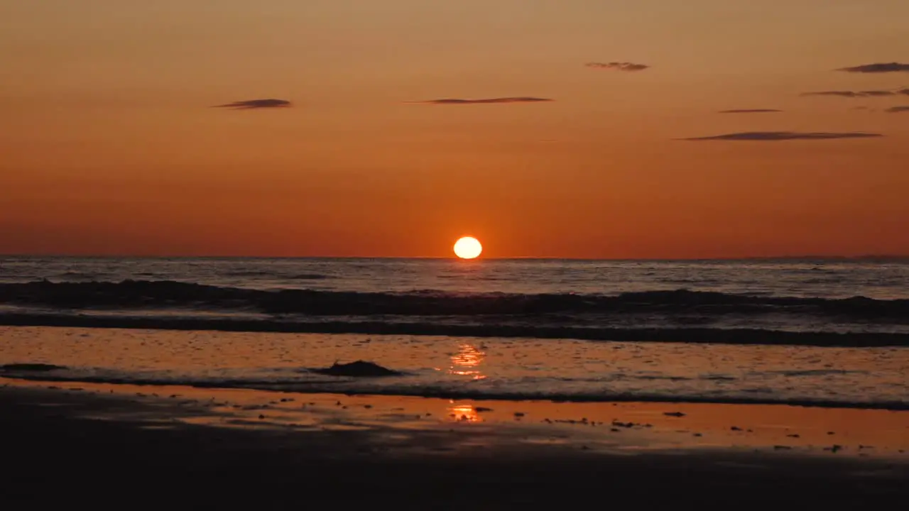 Man running with guitar in back sand beach at sunset-29