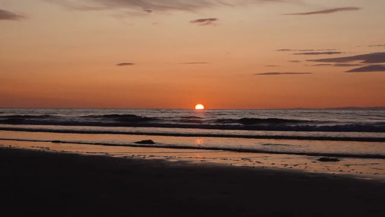 Man running with guitar in back sand beach at sunset-21