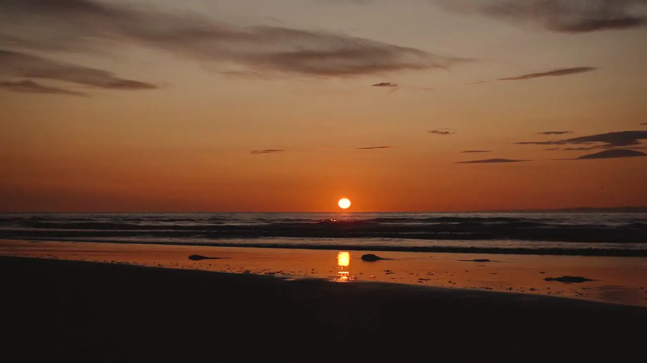 Man running with guitar in back sand beach at sunset-20