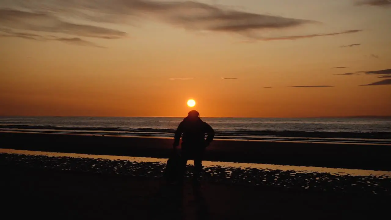 Man running with guitar in back sand beach at sunset-6