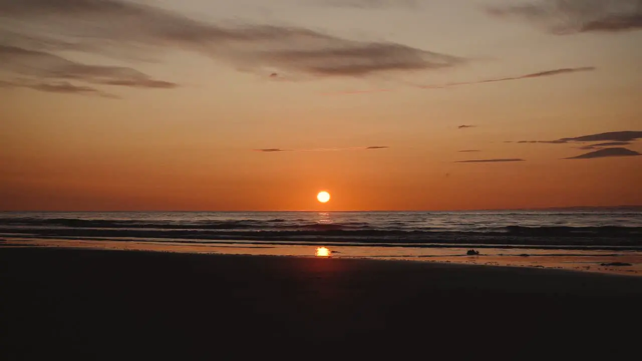 Man running with guitar in back sand beach at sunset-24