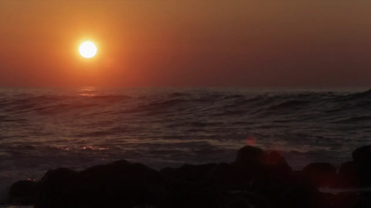 The sun sets behind beautiful ocean waves 1