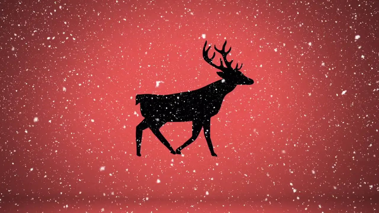 Snow falling over silhouette of reindeer walking against orange background