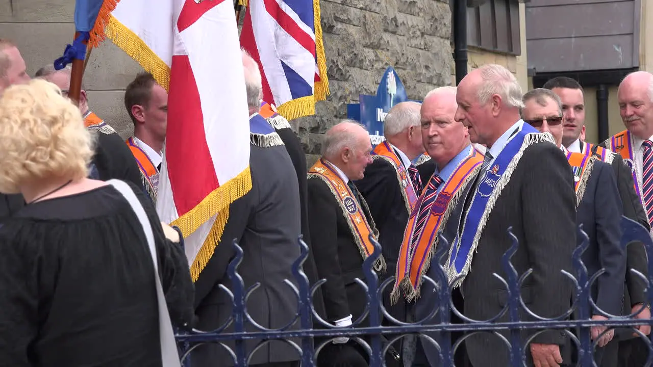 Northern Ireland Orangemen Waving To Onlooker By Church