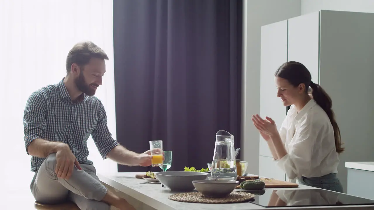 Cheerful Couple Spending Good Time Together In A Modern Style Kitchen