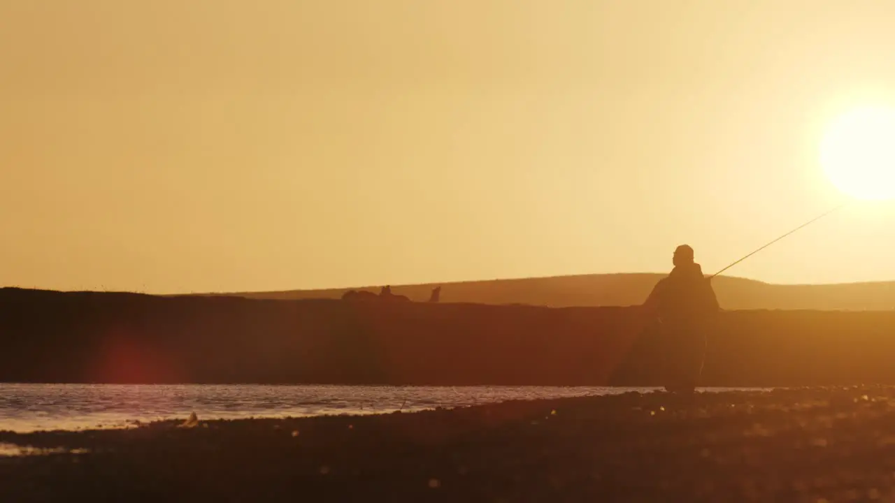 Flyfishing during the sunrise in southern Argentina with calm river and lens flare