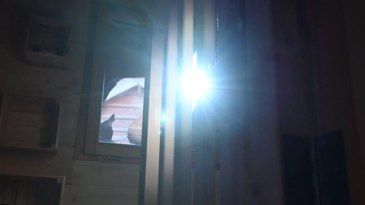 wooden slats in a hut perched in a french forest ray of sunshine passing through the window