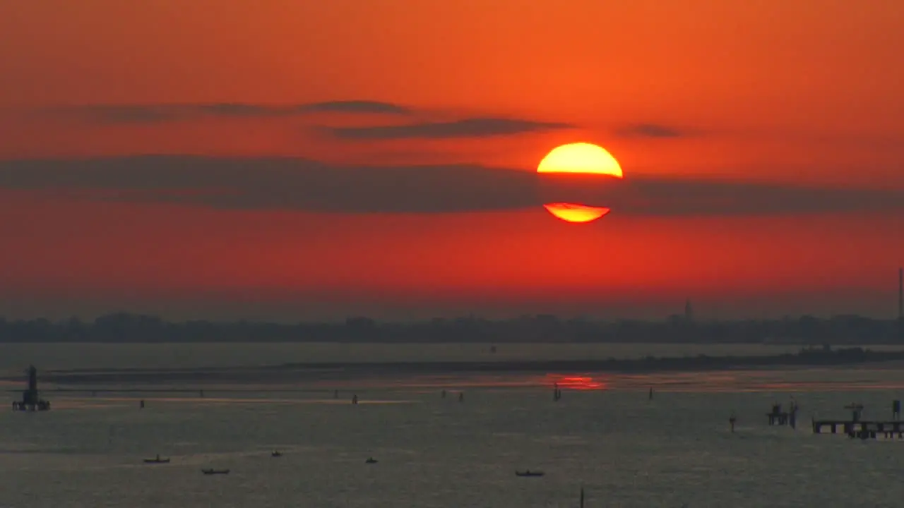 Italy cloud streak over rising sun at the entrance to Venice lagoon