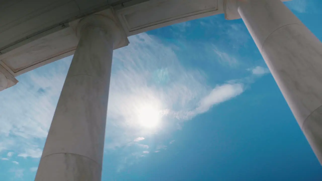 Arlington Cemetery Ampitheater pillars Sun noon Sky Clouds Sliding Shot