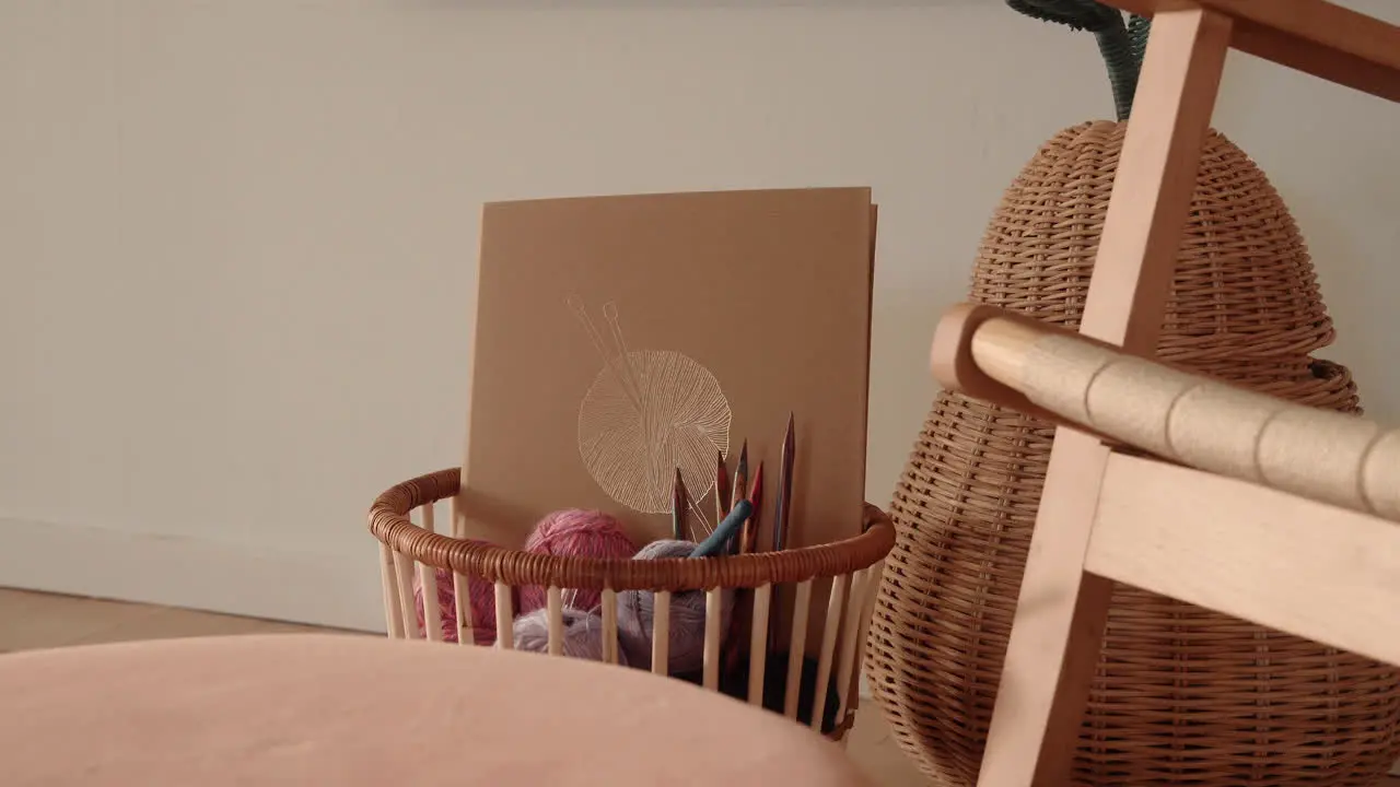 Knitting equipment in a basket wool and needles sunlit living room