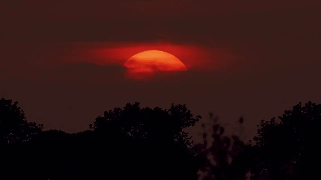 Setting sun behind clouds during dusk