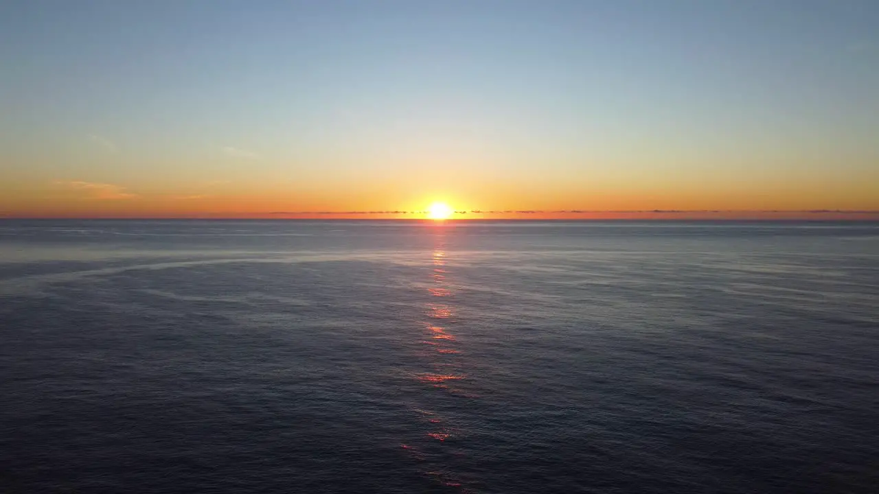 Sunrise over sea with lighthouse