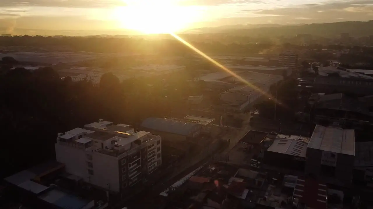 Sunrise view from Calzada Atanasio Tzul overpass construction in zona 12 Guatemala City showing two gas station