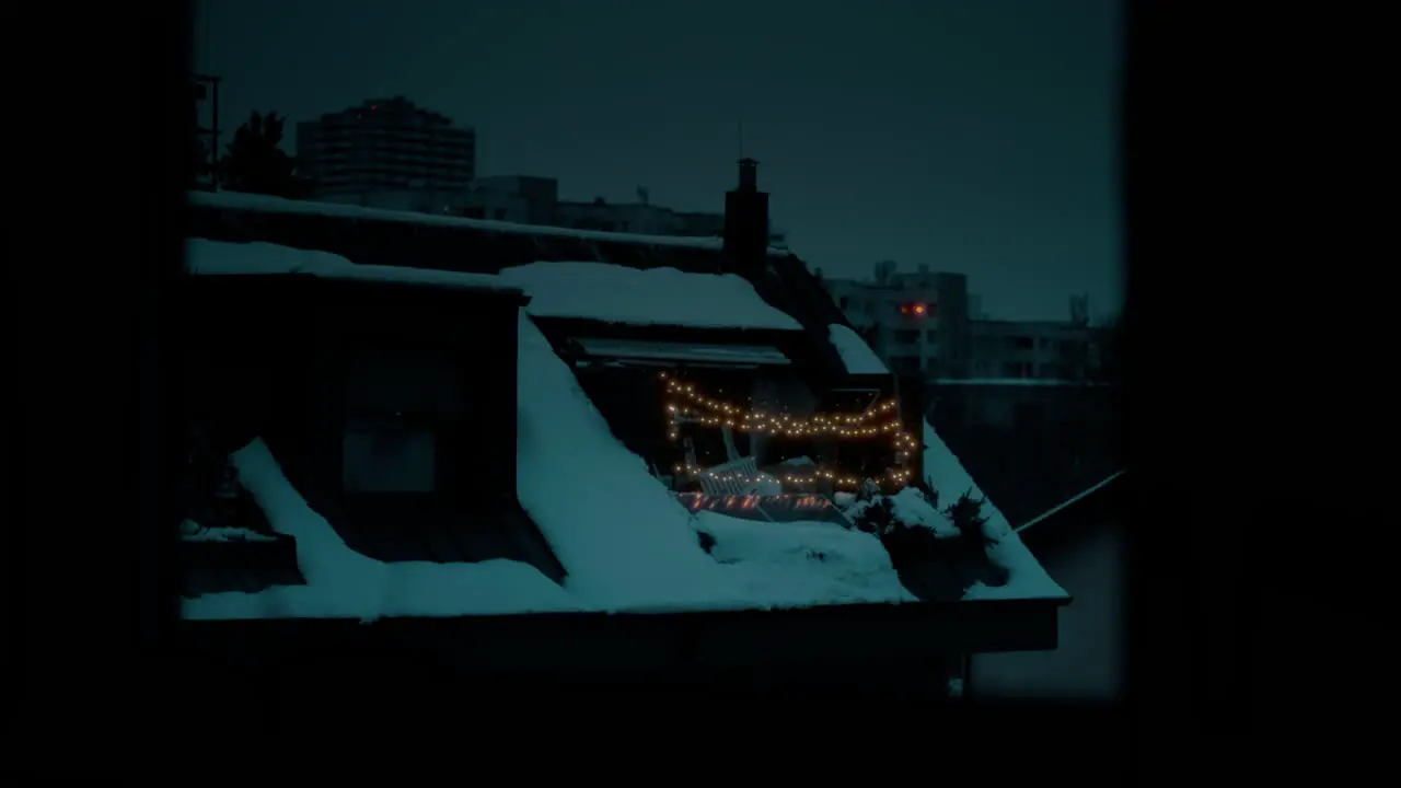 Cinematic shot of a House covered in snow with Christmas lights shining during a night