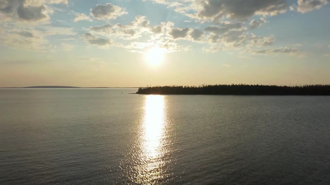 Aerial shot of a sunset over a large lake in northern Canada