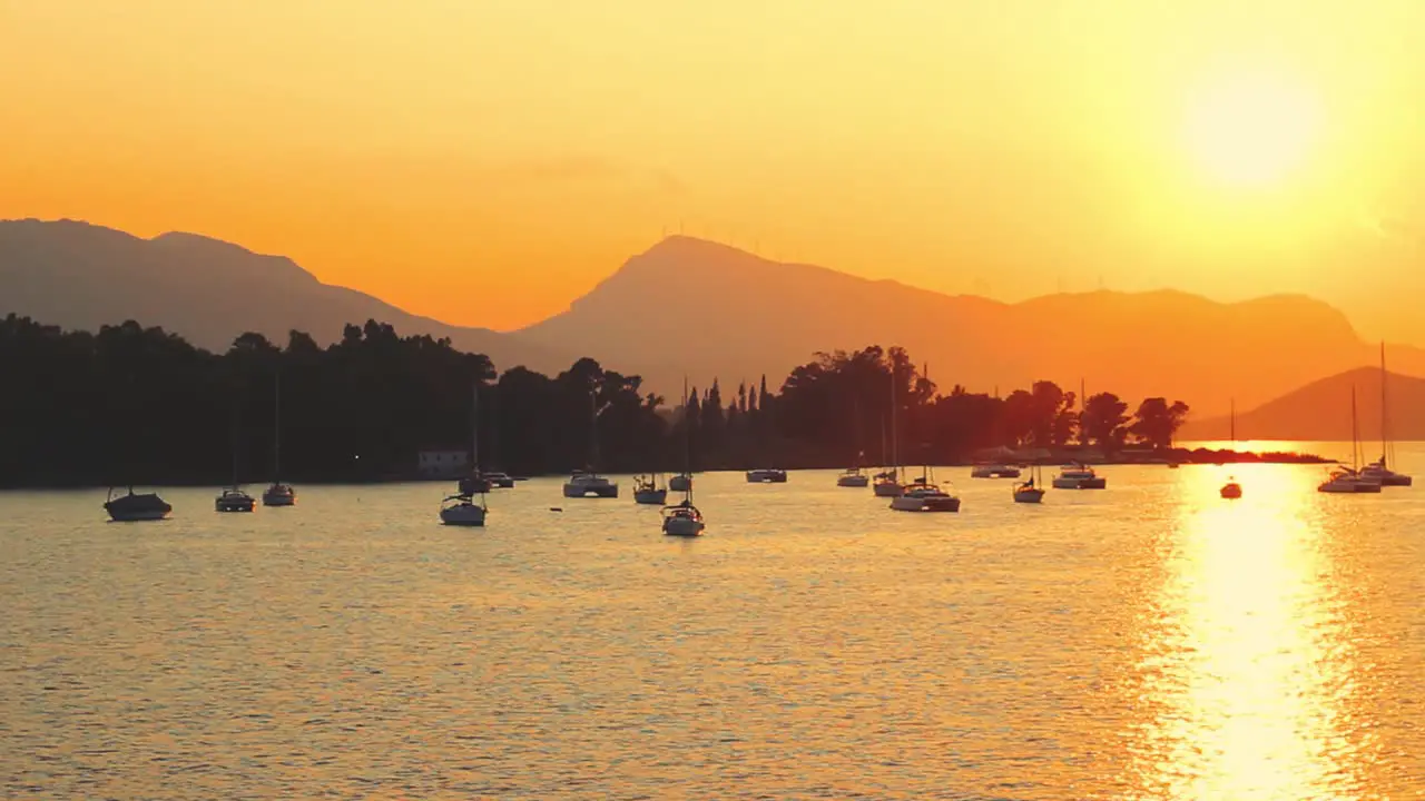 Yachts and sailboats in bay on beautiful golden sunset