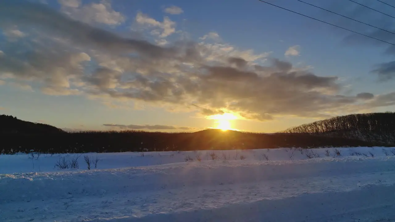 Driving Past Golden Yellow Sunset In Snow Winter Landscape Road In Hokkaido