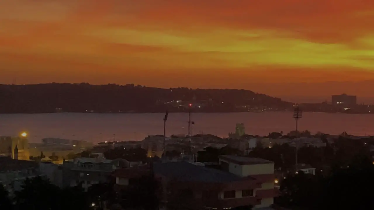 aerial view of caparica from Lisbon over river Tagus in orange silhouette sky