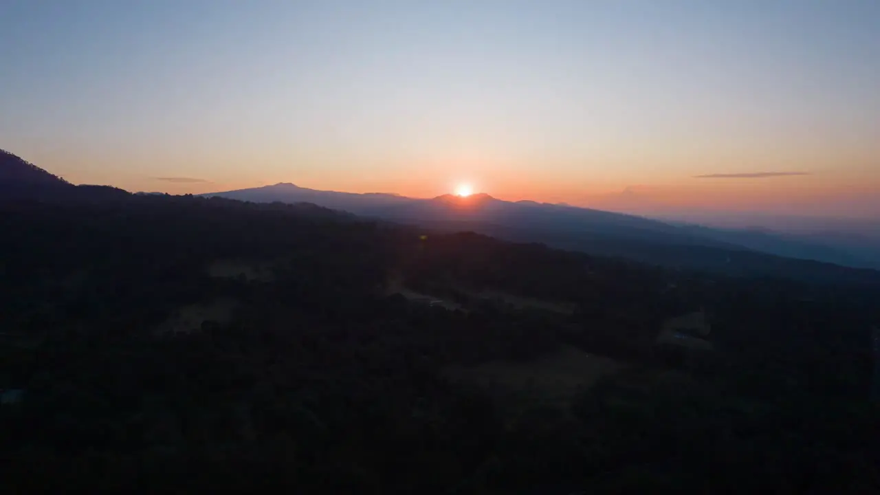 Front to back hyperlapse at sunrise above mountains in Mexico with view of sun