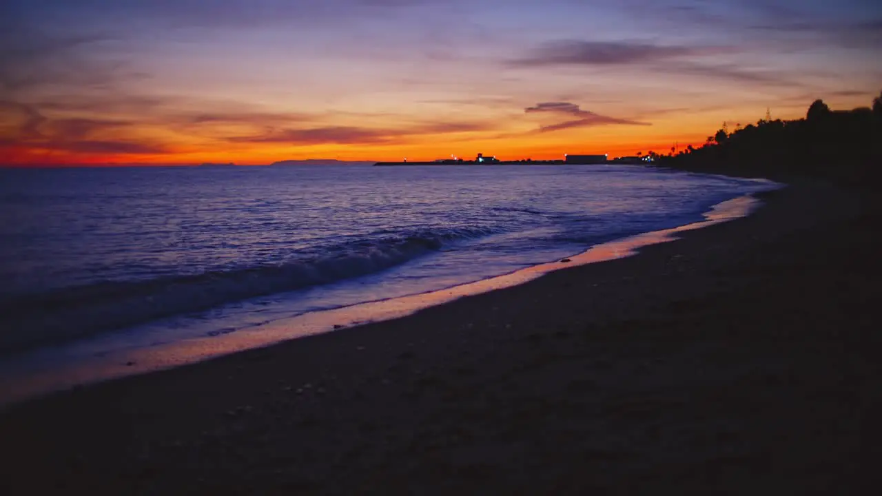 Calm beach waves after sunset