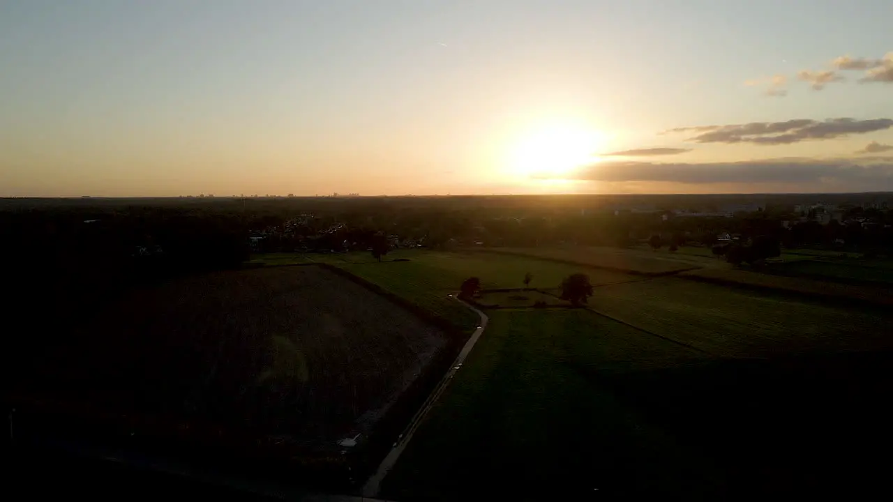 Aerial of sun setting over a peaceful rural landscape in the Netherlands