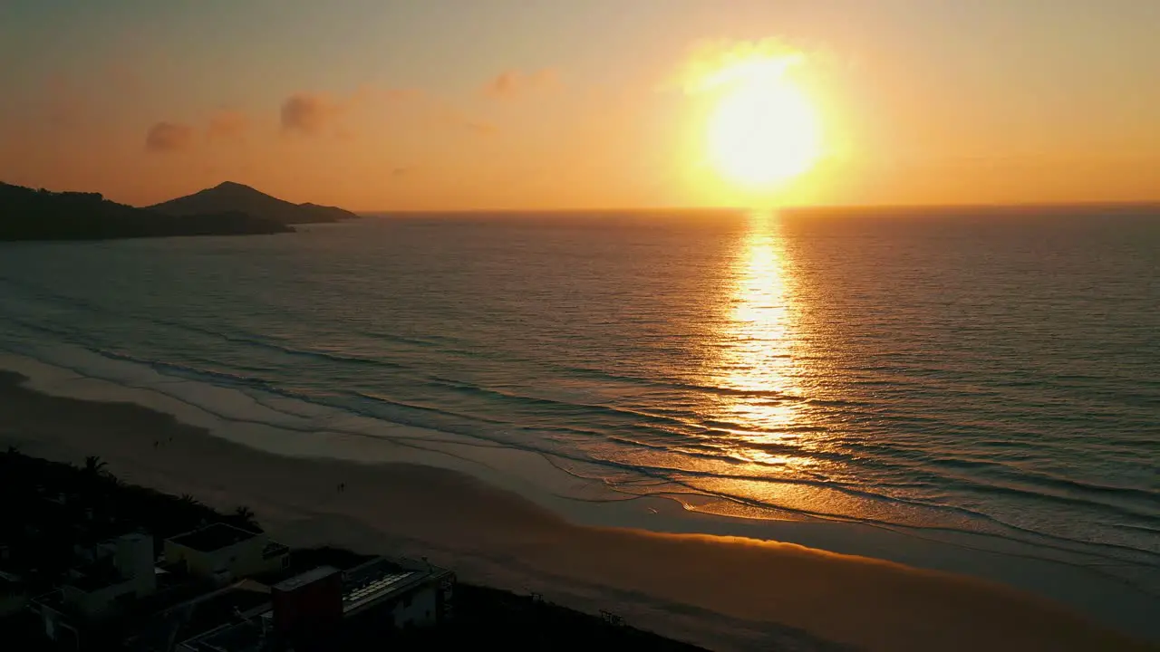 Drone aerial view going up revealing amazing ocean sunset South America Brazil