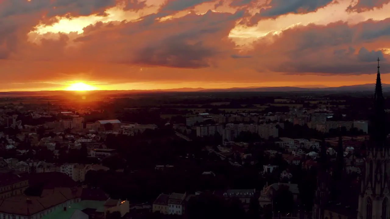 Aerial View of Idyllic Summer Sunset and Dramatic Sky Above Small European City