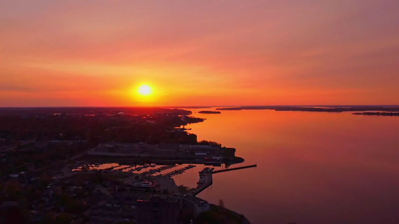 Aerial orange sky sunrise over a city waterfront