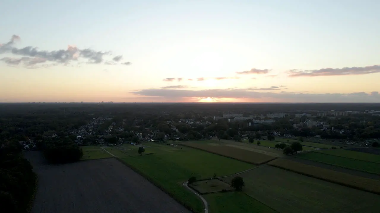 Jib down of a typical dutch landscape at the edge of town at sunset