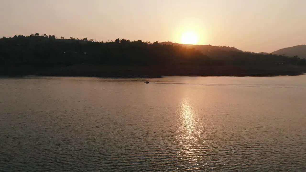 Lonavla lake drone fallows motor bike in sunset 4k cinematic