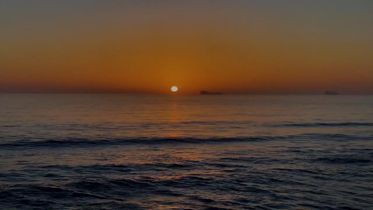 Time-Lapse Fast Glowing Sunset with some boats sailing