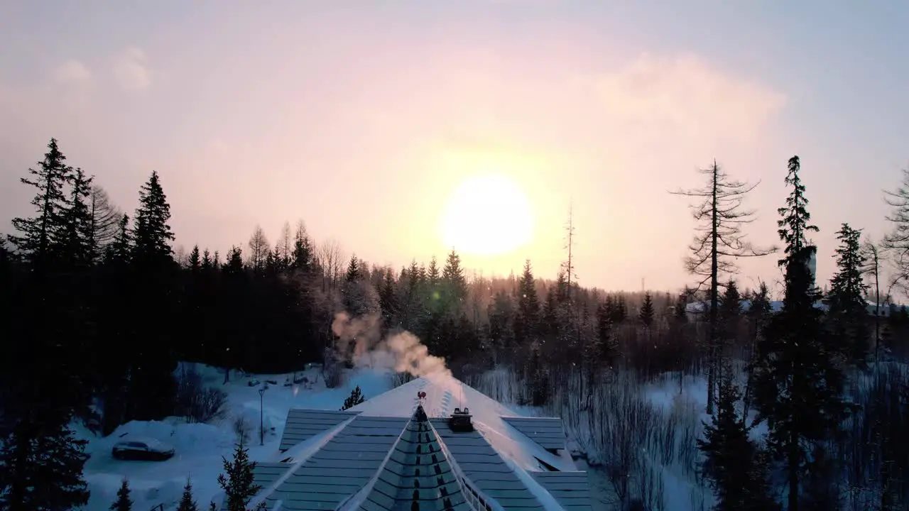 A breathtaking view opens up when flying over the cottage with a roof covered in snow