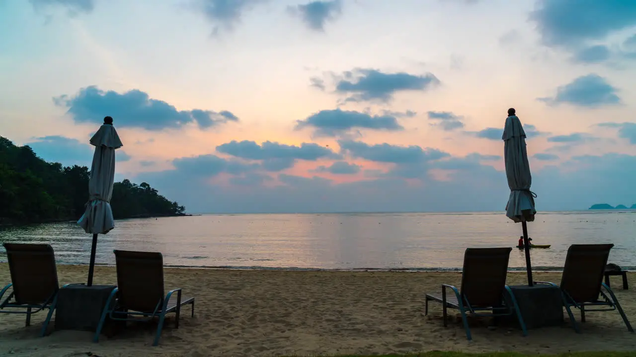 Timelapse Sunset with umbrella deck chair pool on beach