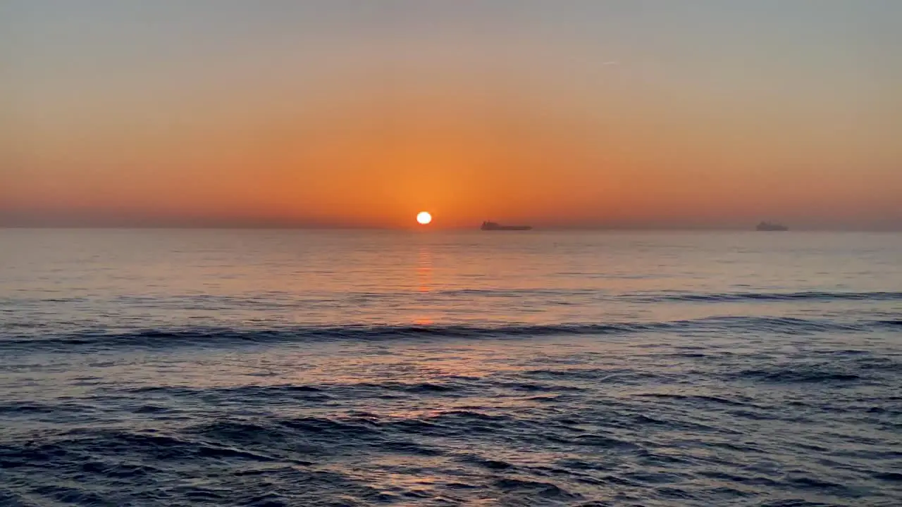 cinematic view shot of a beautiful ocean sunset above sea