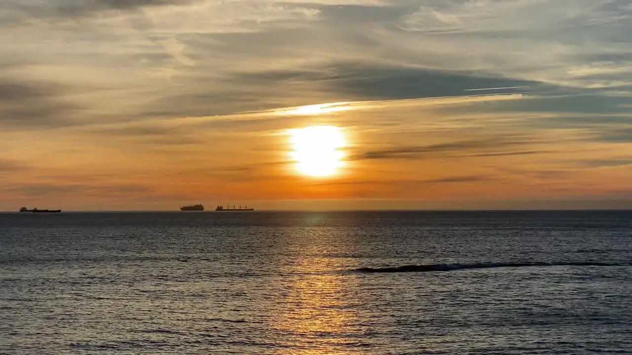 Beautiful sunset on coastline tropical beach with golden sea and silhouette travel people on nature background 4K