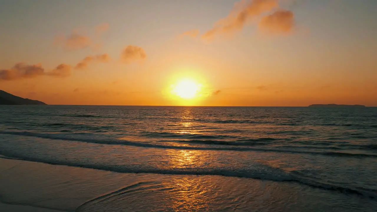 Drone aerial view dynamic shot over beautiful ocean sunrise