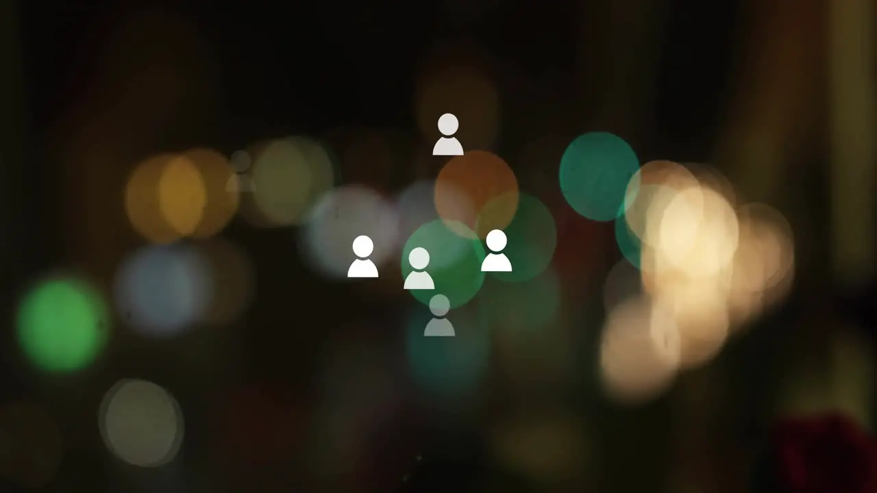 Animation of social media icons over light spots on black background