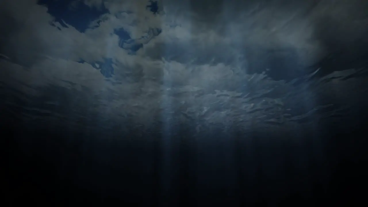 Background animation of being underwater looking up through the surface of the water at a cloudy sky