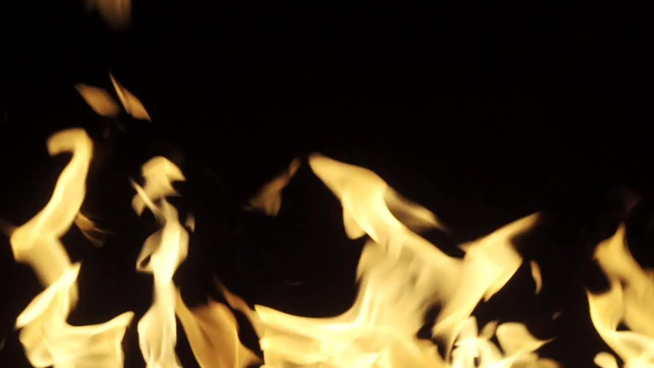 Slow motion of flames coming off a fire at night time