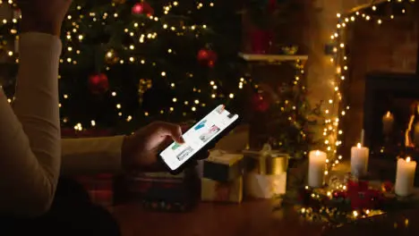 Christmas At Home With Person Online Shopping on Mobile Cell Phone