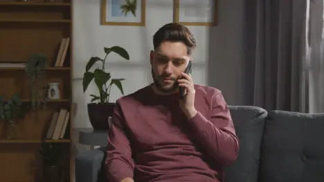 Young Man At Home Receiving Phone Call Telling Him He Has Been Unsuccessful In Job Interview 3