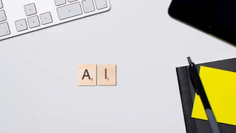 Stop Motion Business Concept Above Desk Wooden Letter Tiles Forming Acronym AI 1