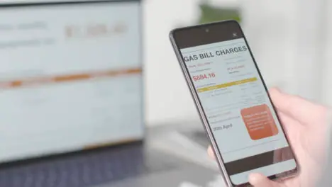 Person Mobile Phone Screen Online Balance Owed US Gas Energy Account