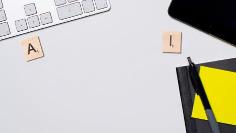 Stop Motion Business Concept Above Desk Wooden Letter Tiles Forming Acronym AI