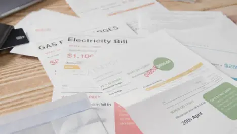 Close Up Of Person Opening Overdue US Energy Bill Pile Utility Debts